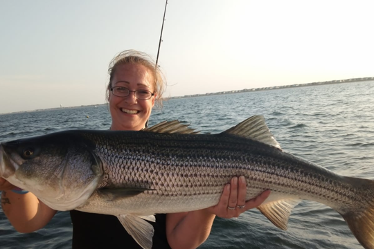 a person holding a fish in the water