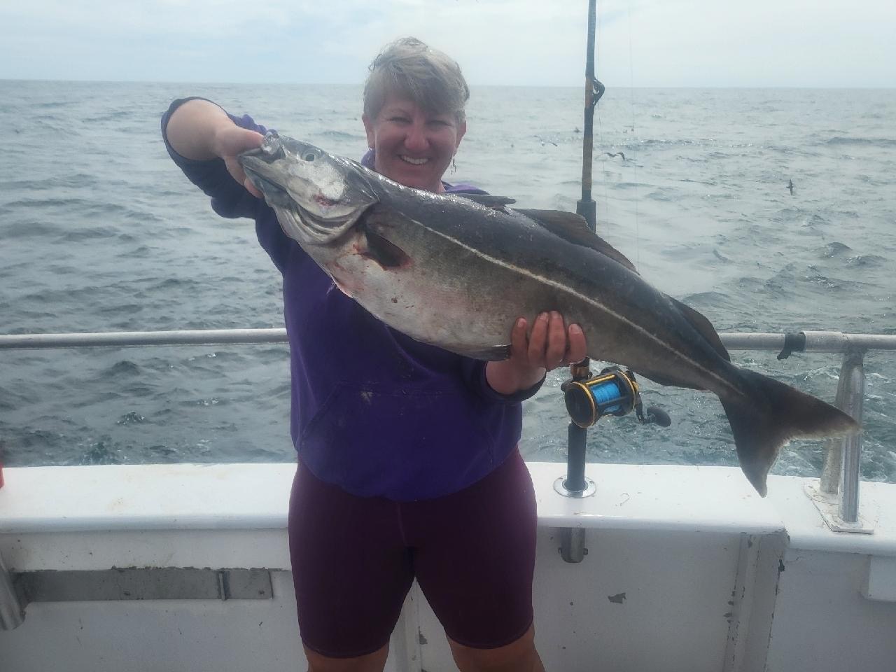 a person holding a fish in the water