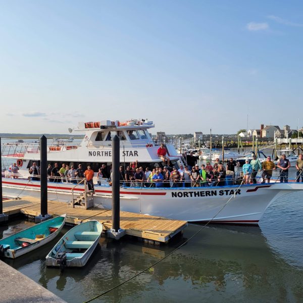 a boat is docked next to a body of water