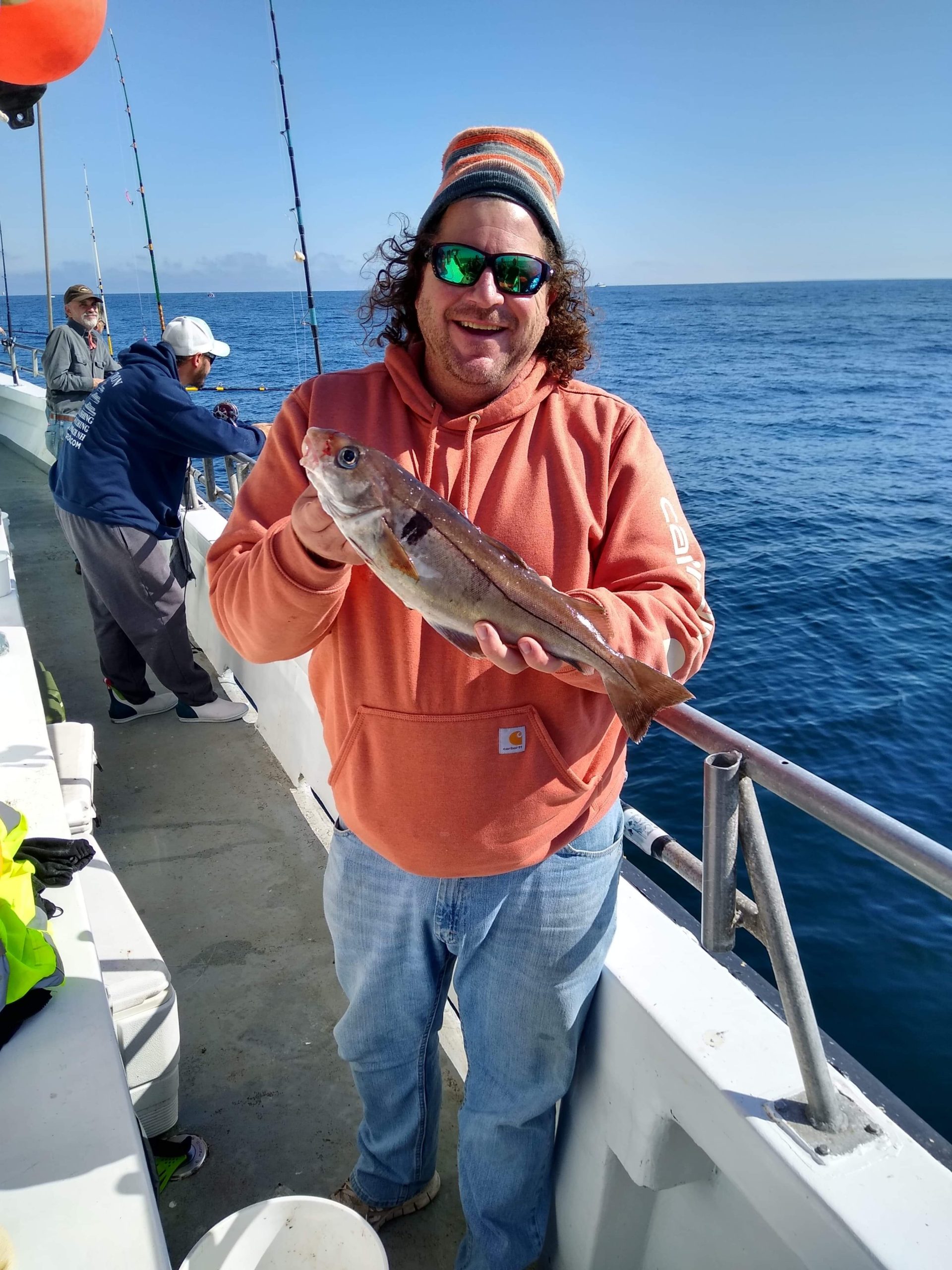 a person holding a fish on a boat