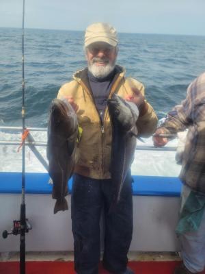 a man holding a fish in the water