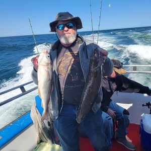 a person holding a fish on a boat in the water