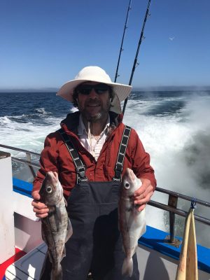 a man and a dog on a boat