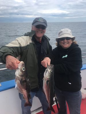 a man holding a fish in the water