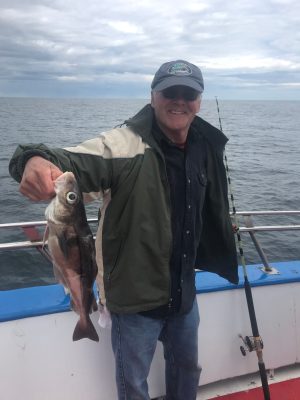 a man holding a fish in the water