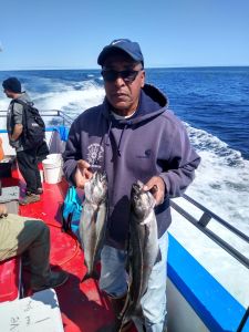 a man holding a fish in the water