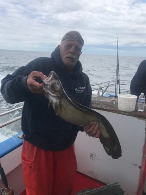 a man standing next to a body of water