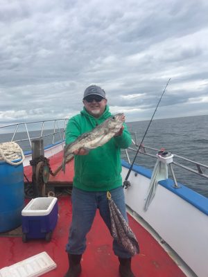 a man and a woman standing on a boat
