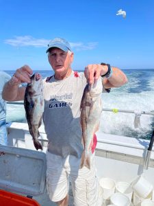 a person holding a fish on a boat