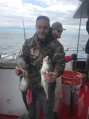 a man holding a fish in the water