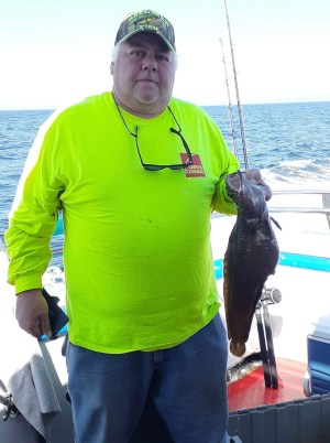 a man holding a fish