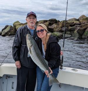 a man holding a fish in the water
