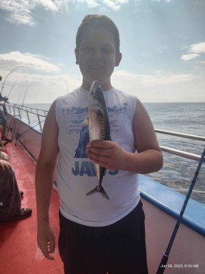a person standing next to a body of water