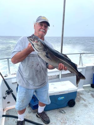 a man holding a fish in the water