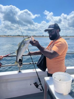 a person standing next to a body of water