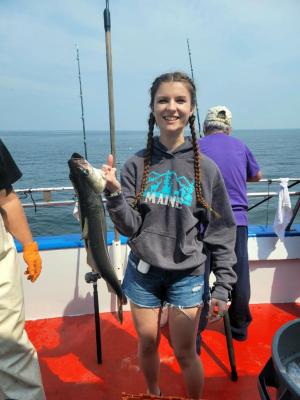a person holding a fish in the water