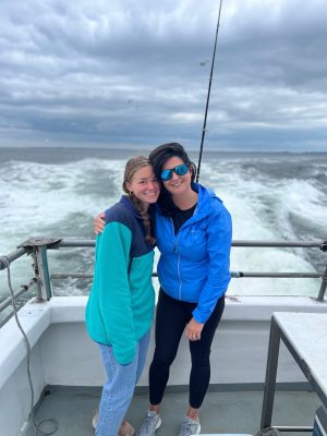 a person standing next to a body of water