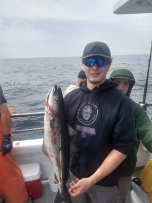 a person holding a fish on a boat in the water