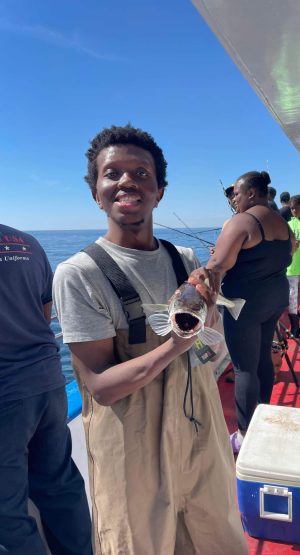 a man and a woman standing in front of water