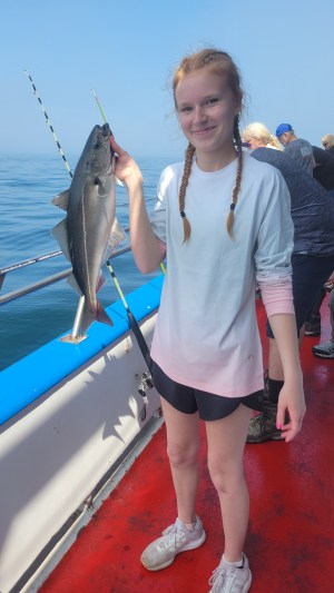 a person holding a fish in the water