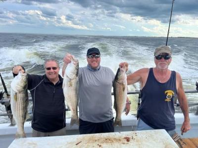 a group of people standing next to a body of water