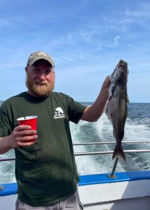 a man holding a fish in the water