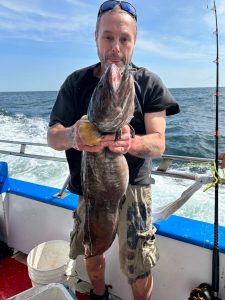 a man holding a fish in the water