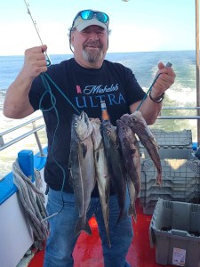 a man holding a fish in the water