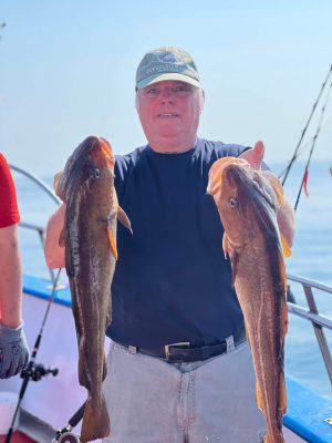 a person holding a fish on a boat