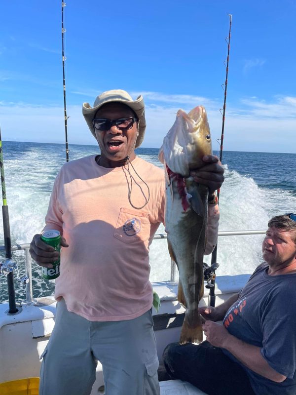 a person holding a fish in the water