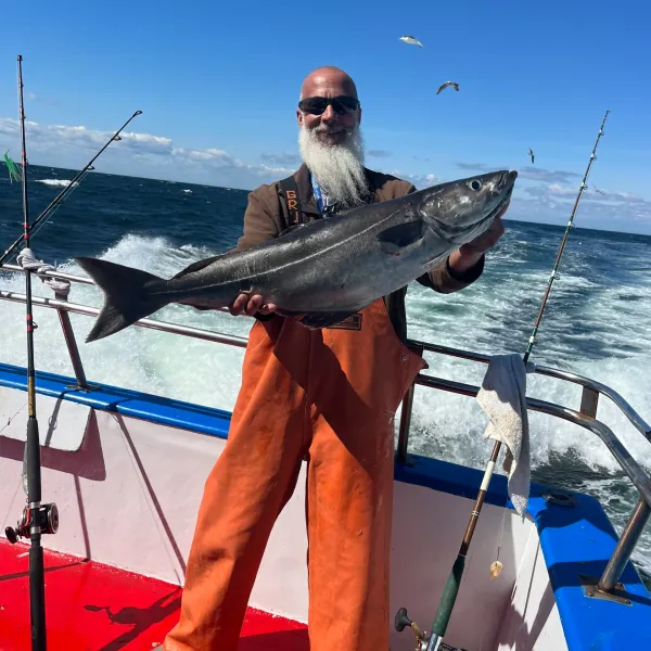a person standing next to a body of water