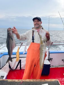 a person holding a fish in the water