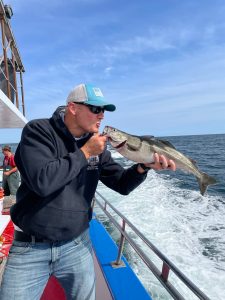 a man holding a fish in the water