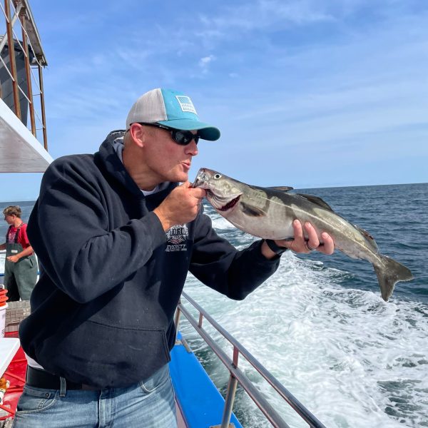 a man holding a fish in the water