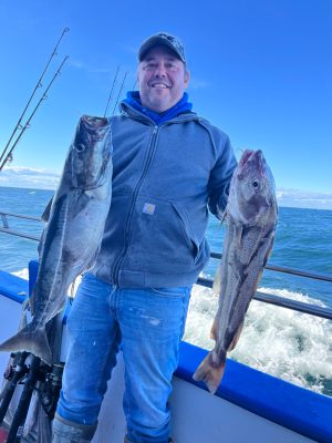 a person holding a fish in the water