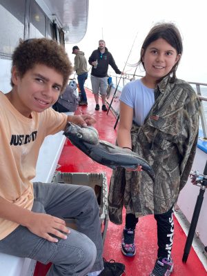 a young boy standing next to a child
