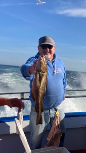 a man holding a fish in the water