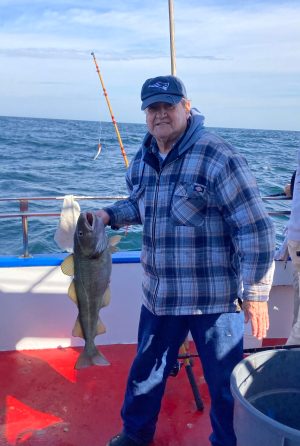 a man holding a fish in the water