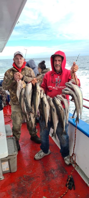 a man holding a fish on a boat