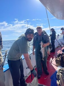 a group of people standing on a boat