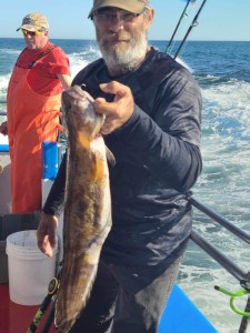 a man holding a fish in the water