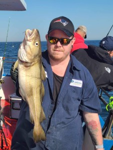 a man holding a fish