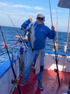 a man standing next to a body of water