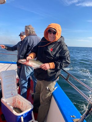 a person holding a fish on a boat