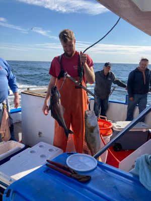 a group of people standing on a boat in the water