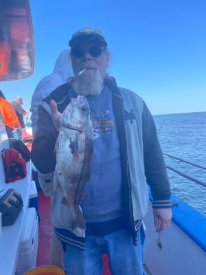a man holding a fish in the water