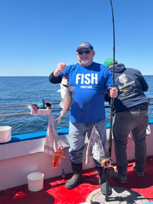 a man holding a fish in the water