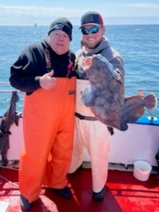 a man holding a fish in the water