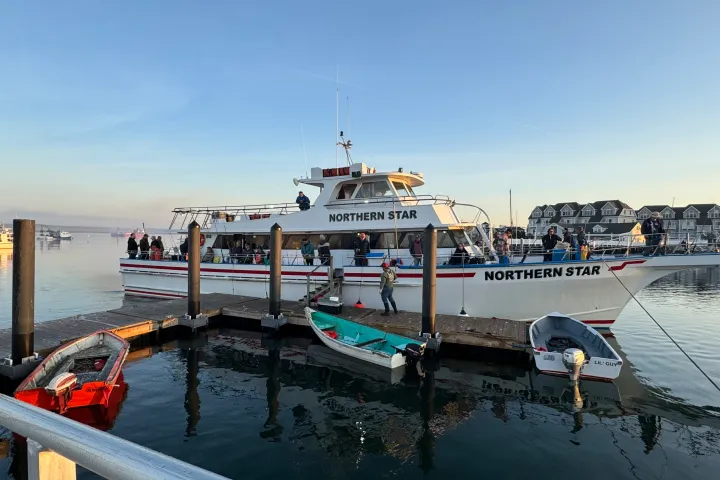 a boat is docked next to a body of water