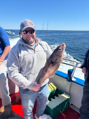a person holding a fish in the water